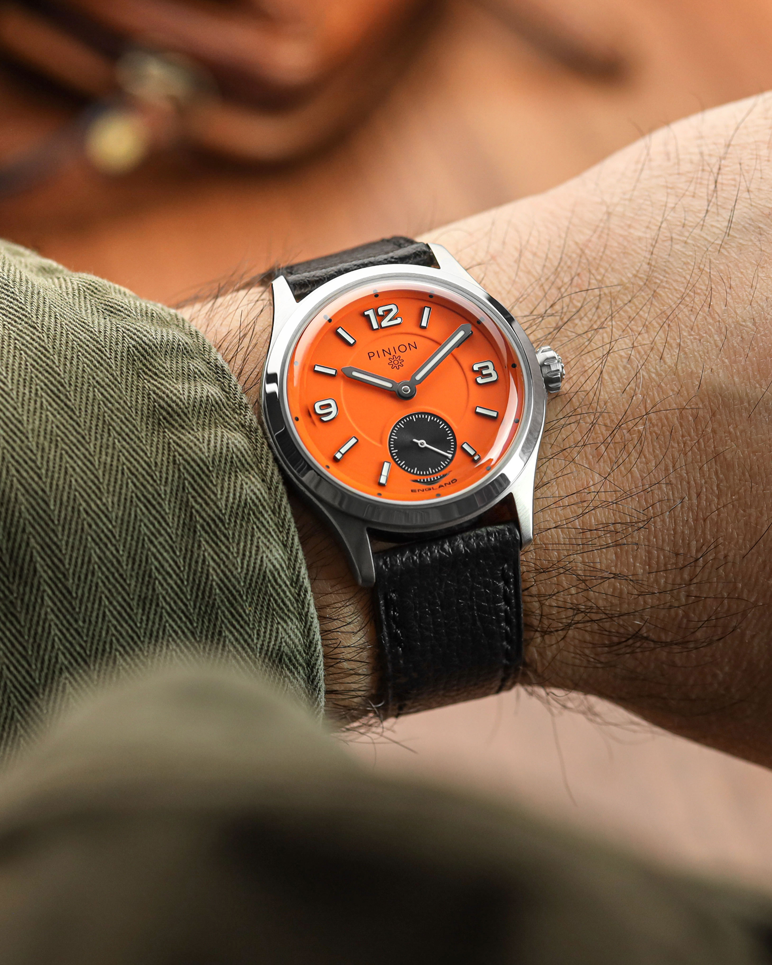 Pinion Pure - A 38mm steel handwound watch with orange dial